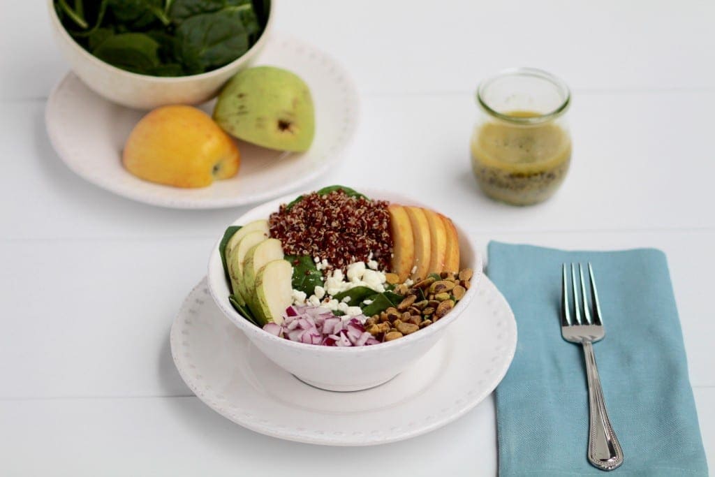 simple apple, pear, quinoa salad + lemon poppyseed dressing | freshen up lunchtime with this delicious and simple quinoa and spinach salad with apples, pears, pistachios, and topped with a homemade lemon poppyseed vinaigrette. | www.nourishmovelove.com