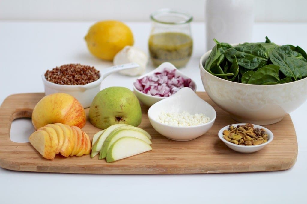 simple apple, pear, quinoa salad + lemon poppyseed dressing | freshen up lunchtime with this delicious and simple quinoa and spinach salad with apples, pears, pistachios, and topped with a homemade lemon poppyseed vinaigrette. | www.nourishmovelove.com