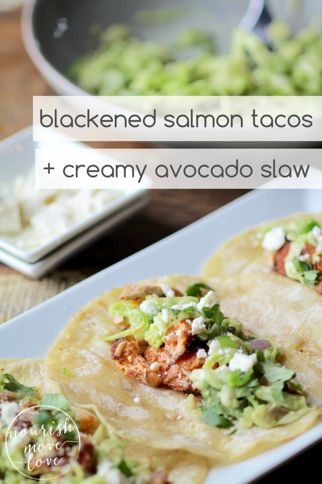 blackened salmon tacos + creamy avocado slaw | seared blackened salmon tacos topped with a creamy avocado slaw, garnished with crumbled cotija cheese and cilantro. | www.nourishmovelove.com