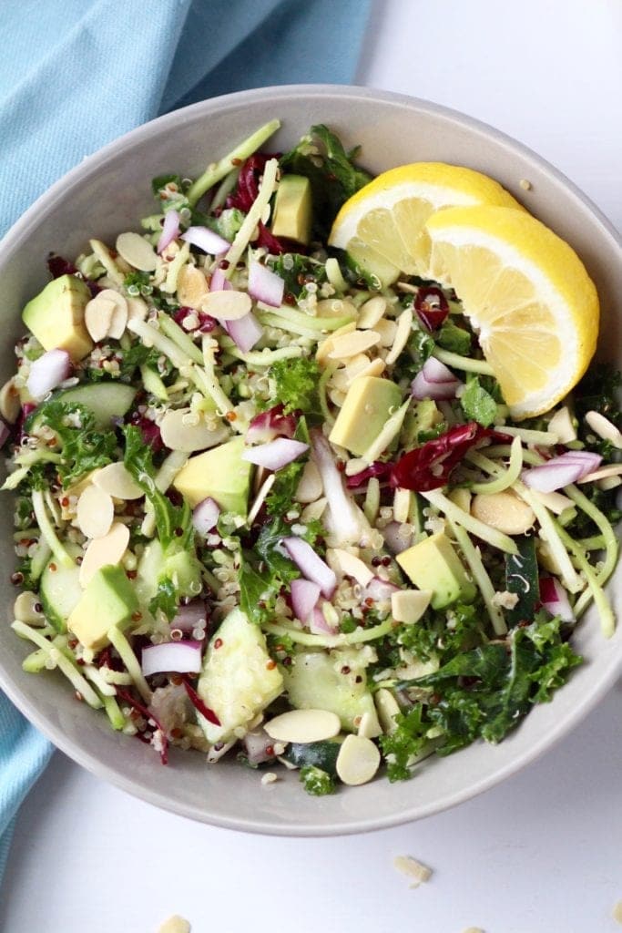 quinoa salad with greens and lemon in a bowl