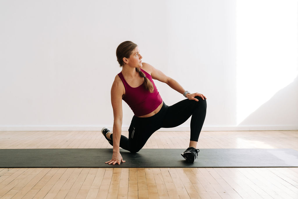 woman performing a hip opening stretch as part of an active recovery yoga flow