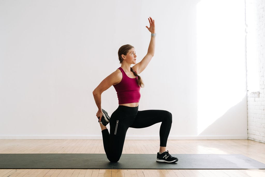 woman performing a quad stretch as part of recovery yoga stretches
