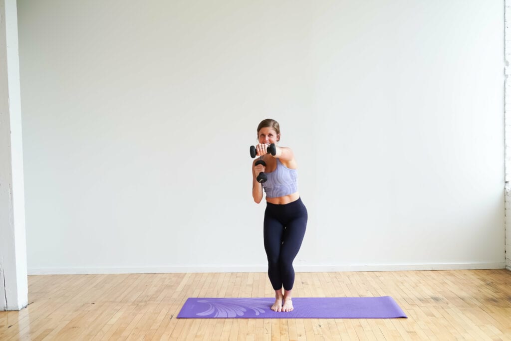 Woman performing a Chair Squat + Punch | barre workout