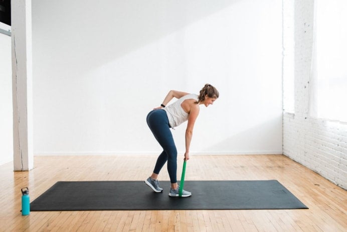 woman performing a single leg deadlift with a resistance band in a booty band workout