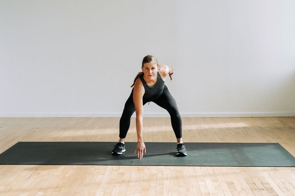 Woman holding a low squat in The Best Strength + HIIT Home Workout for Women