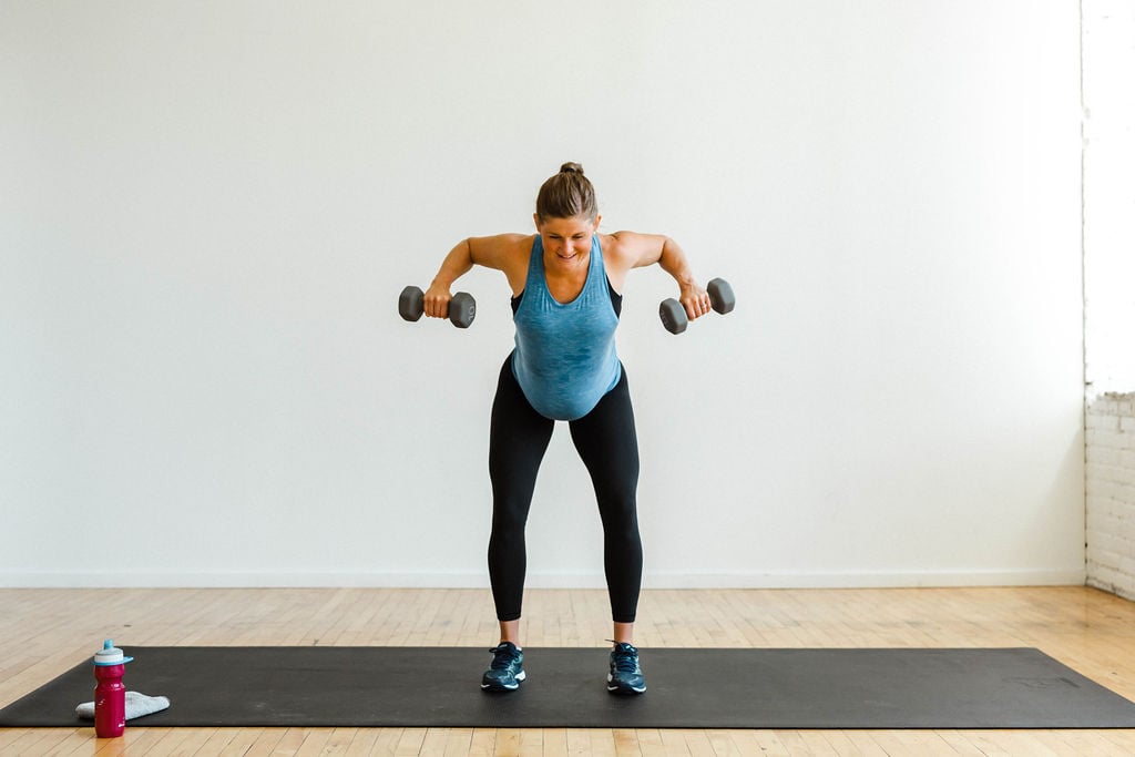 woman performing a a double arm back row as part of a dumbbell arm workout