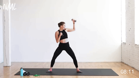 woman performing a sumo squat and punch in a cardio barre workout