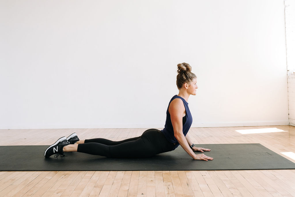 Women performing a cobra stretch to open tight shoulders, chest and neck during a full body stretch routine. 