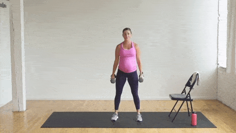 pregnant woman performing a squat and curl and press in a prenatal strength workout