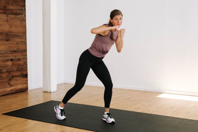 Woman performing a front punch in a Cardio Kickboxing Tabata Workout