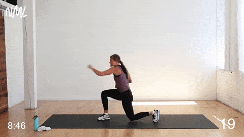woman performing a side to side lunge and crossbody jab in a cardio kickboxing workout