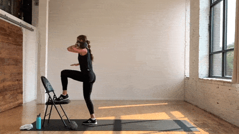 woman performing a kettlebell step up and knee drive in a kettlebell AMRAP workout