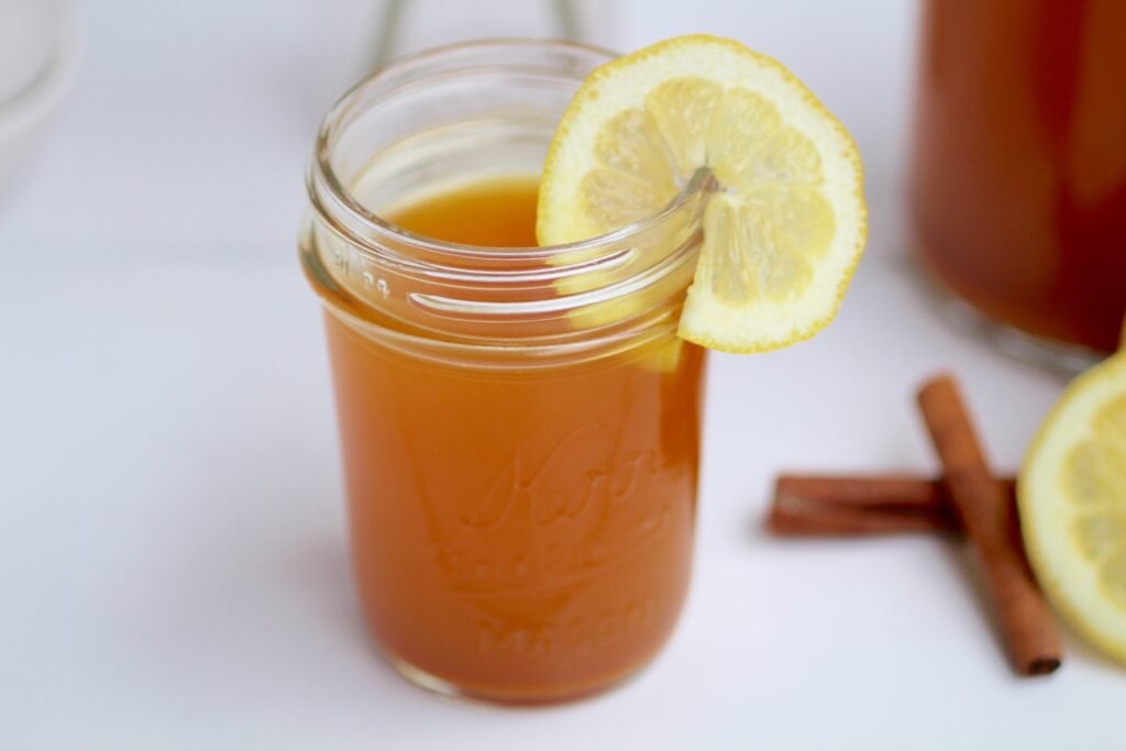 homemade lemon ginger turmeric tea in a mason jar to support the immune system and maintain a healthy digestive system