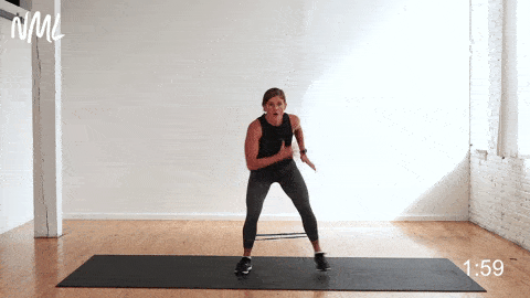 woman performing a banded monster walk to challenge the frontal plane as part of glute activation exercises