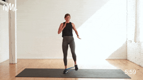 Banded Squat + Knee Drive for hip flexion and glute activation - a great warm up exercise for runners