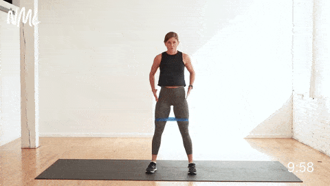 woman performing banded squats for glute activation 