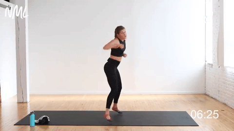 woman performing a jab cross speedbag in a cardio kickboxing workout at home
