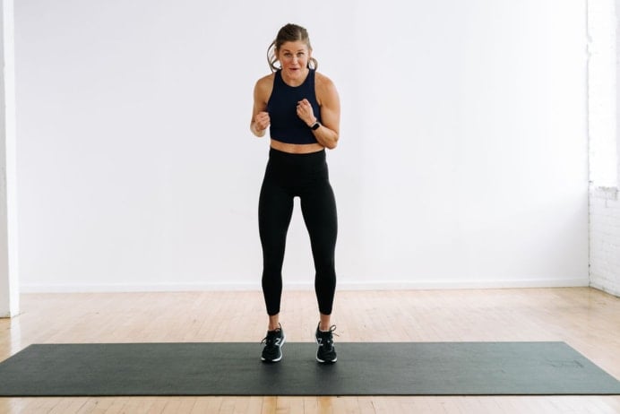 Woman performing alternating jabs in a fat burning chipper workout