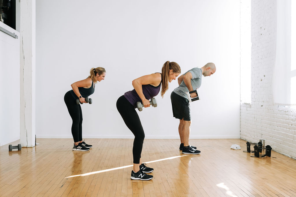 three people performing back rows with dumbbells in a circuit workout