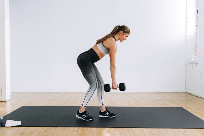 Women performing a Single arm dumbbell row | legs and back workout