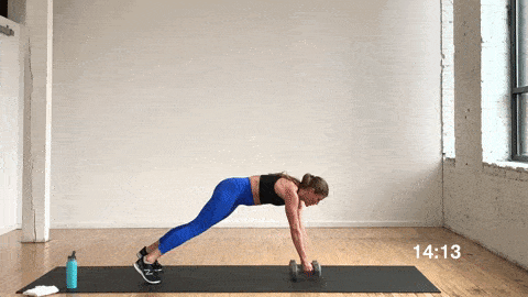 woman performing a plank and row for building strength