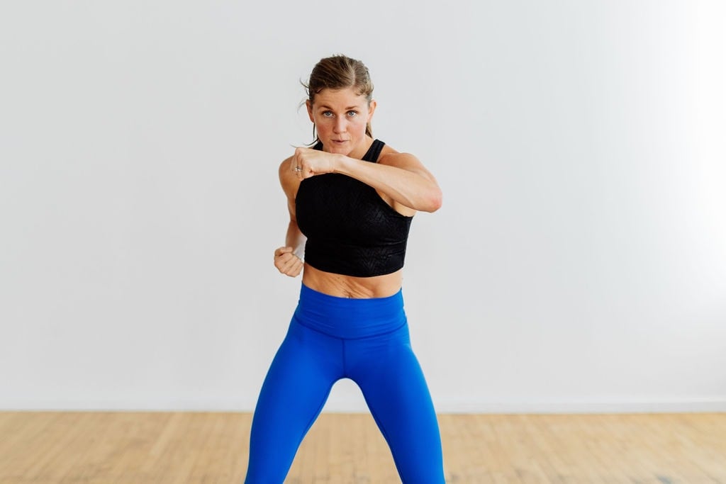 woman performing a front punch as part of full body resistance training