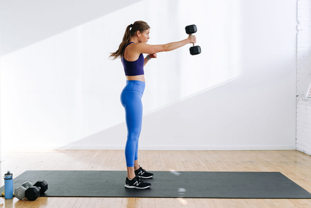 woman performing a dumbbell swing hip hinge