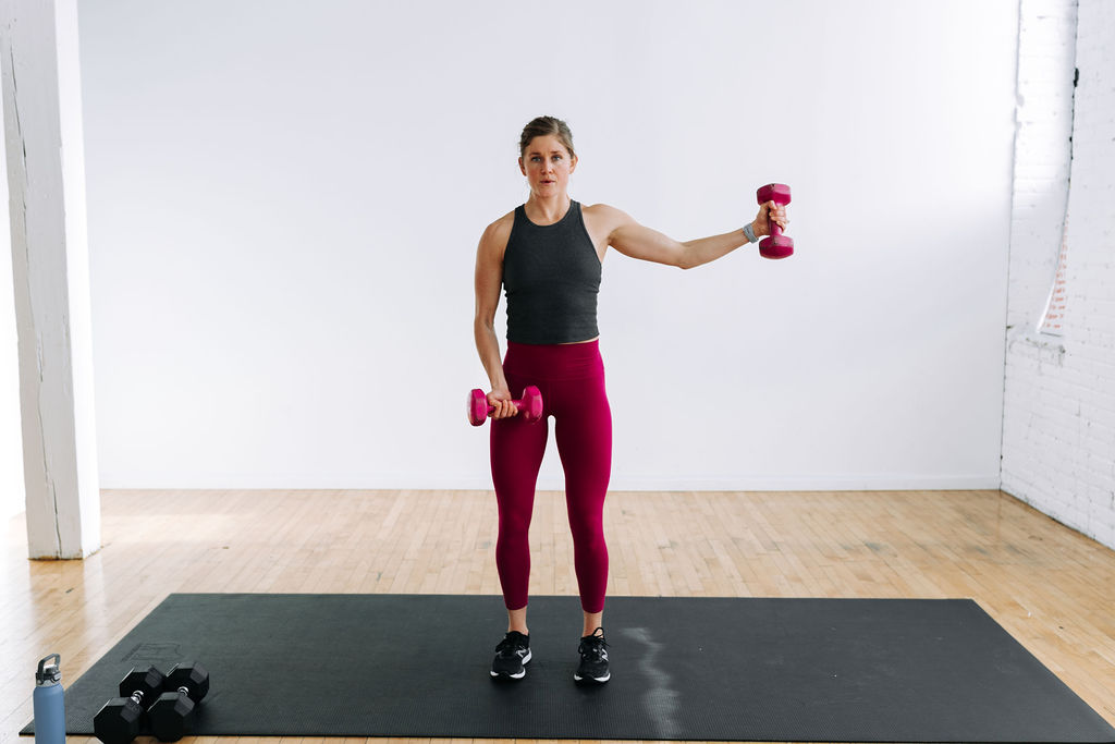 Push Workout | woman performing a lateral shoulder raise with dumbbells