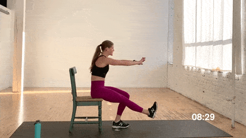 woman performing a single leg chair squat in a lower body workout