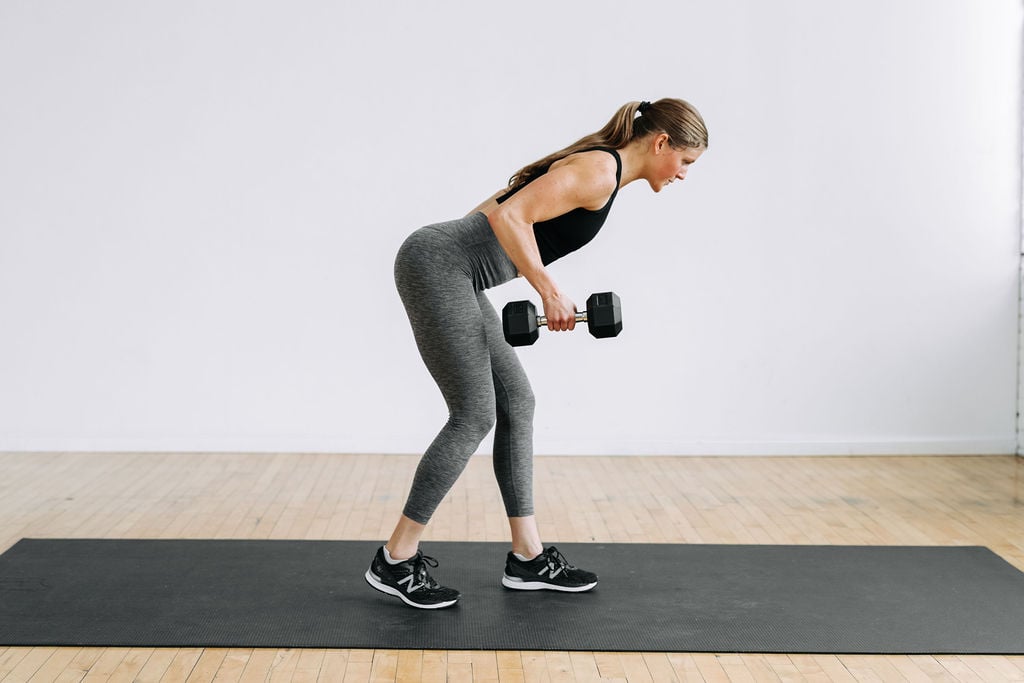 woman performing a single arm back row in a full body workout at home