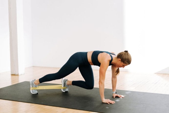 Resistance Band Ab Workout | Woman performing Bear Crawls with Mini Band