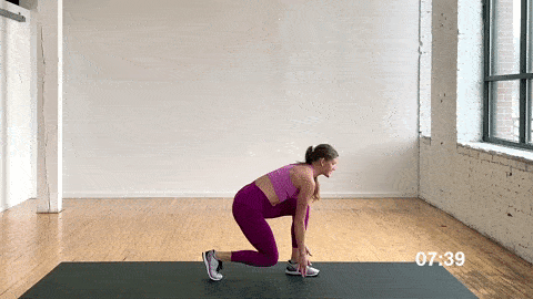 woman performing around the world lunge pivots in a dynamic warm up