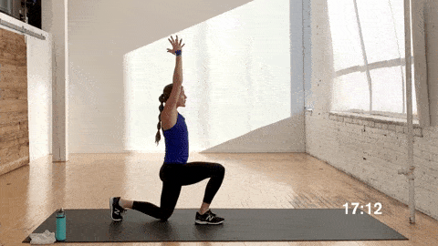 woman performing a banded bicep curl and shoulder press and alternating reverse lunge in a resistance band workout at home