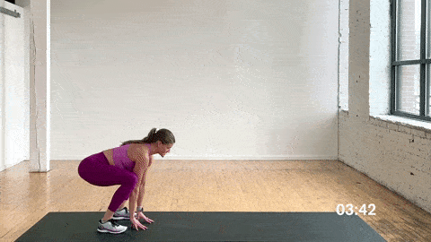 woman performing a plank walk out and low lunge hip opener in a dynamic warm up