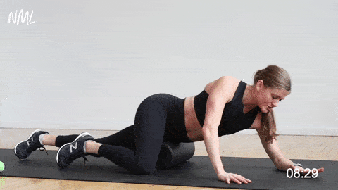 woman performing a quadriceps roll with foam roller for knee pain
