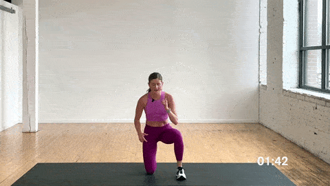 woman performing prisoner gets ups in a dynamic warm up