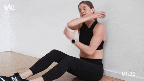 woman using a lacrosse ball for upper back and shoulder mobility in a full body mobility routine 