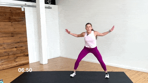 woman performing lateral jack walks as a beginner cardio exercise