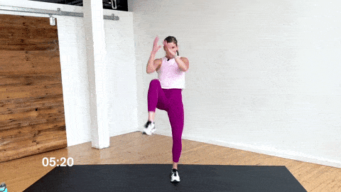 woman performing a knee drive and tap back or rocking horse cardio exercise