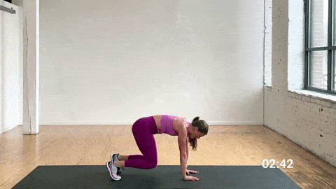 woman performing kick sits in a dynamic warm up