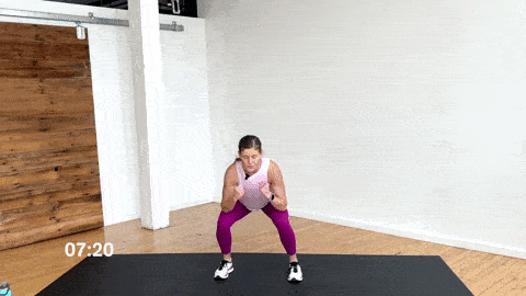 woman performing two jabs and a squat as part of an at home cardio workout