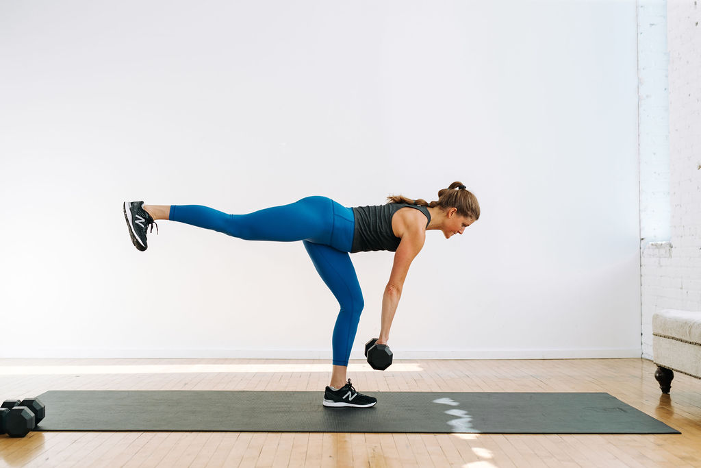 woman performing a single leg deadlift with a single kettlebell or single dumbbell in a full body workout