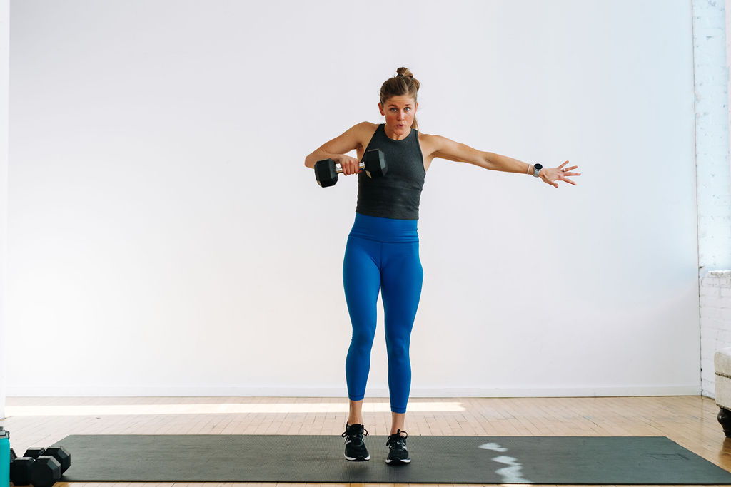 woman performing a high pull in a full body kettlebell workout