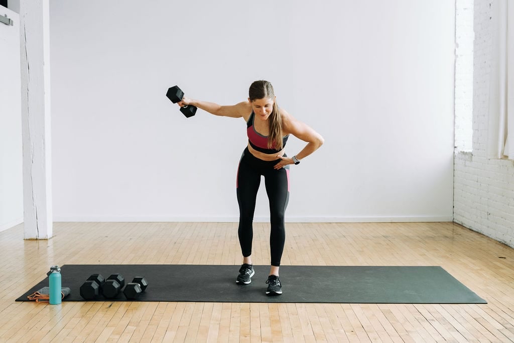 Women performing a single arm dumbbell back fly or reverse fly