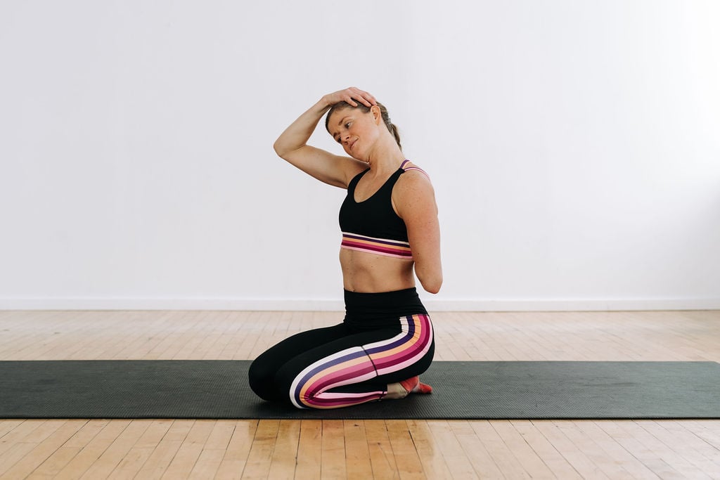 woman stretching her neck and shoulders as part of the best upper body stretches