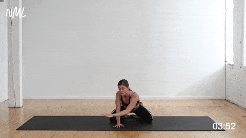 woman performing a child's pose stretch for back pain