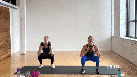 two women performing a kettlebell deadlift clean squat press as part of the best full body kettlebell exercises