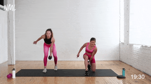 one woman performing a kneeling hinge swing to stand up press and one woman performing a standing hinge swing to overhead press in a cardio abs workout at home