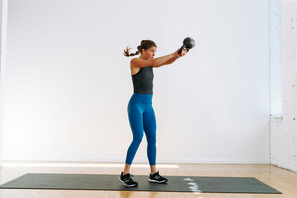 woman performing a kettlebell swing