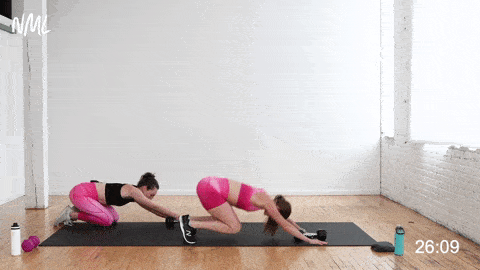 two women performing a plank launcher and t-pull with a dumbbell in a cardio abs workout with weights